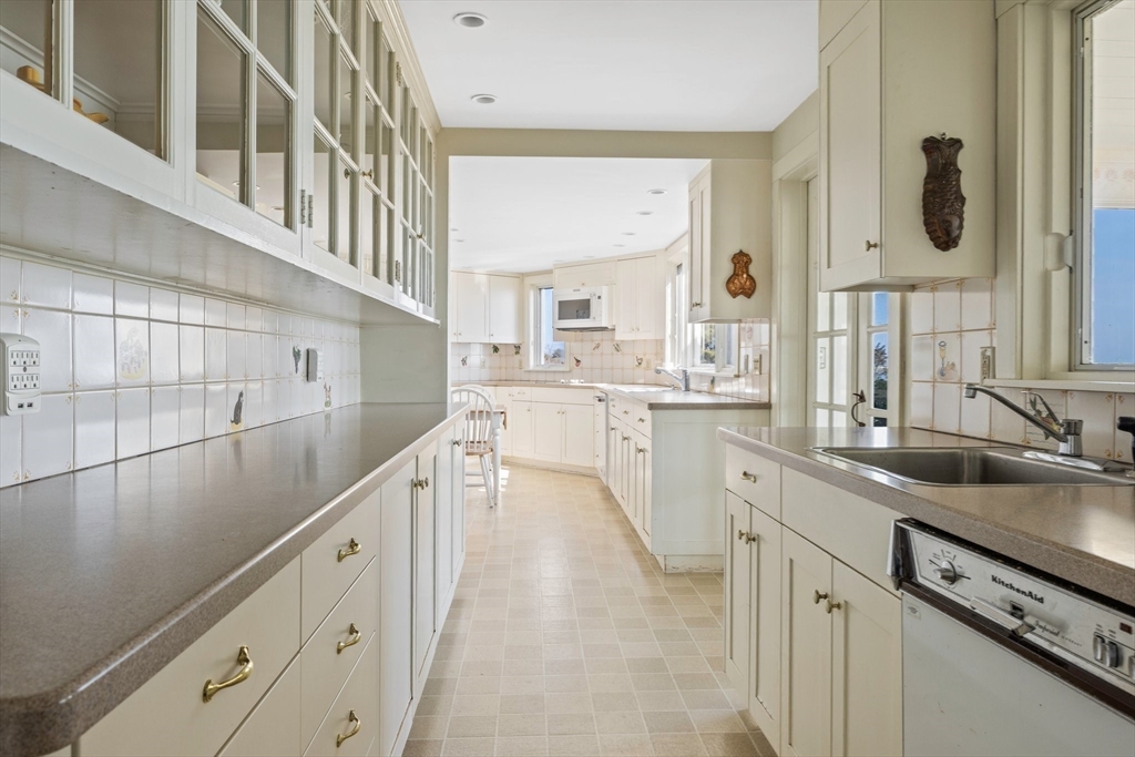 504 Old Harbor Road Chatham, MA 02633 - Photo 16 of 42 a kitchen with cabinets a sink and appliances