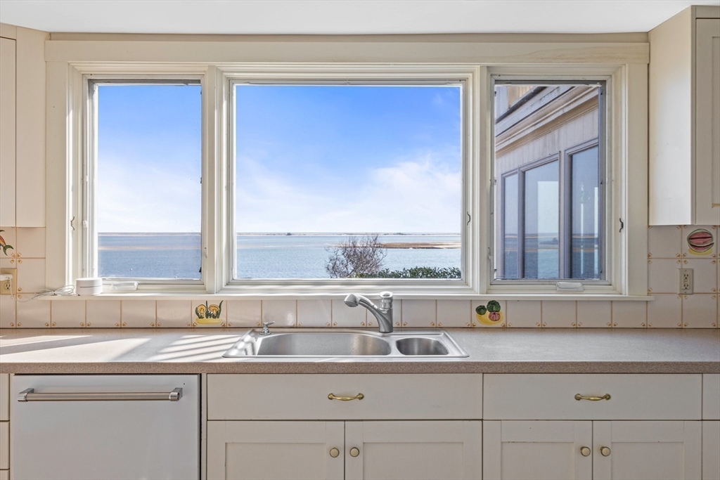 504 Old Harbor Road Chatham, MA 02633 - Photo 18 of 42 a sink with a window and mirror