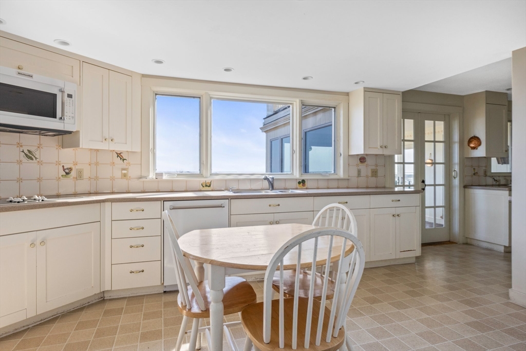 504 Old Harbor Road Chatham, MA 02633 - Photo 20 of 42 a kitchen with white cabinets and sink