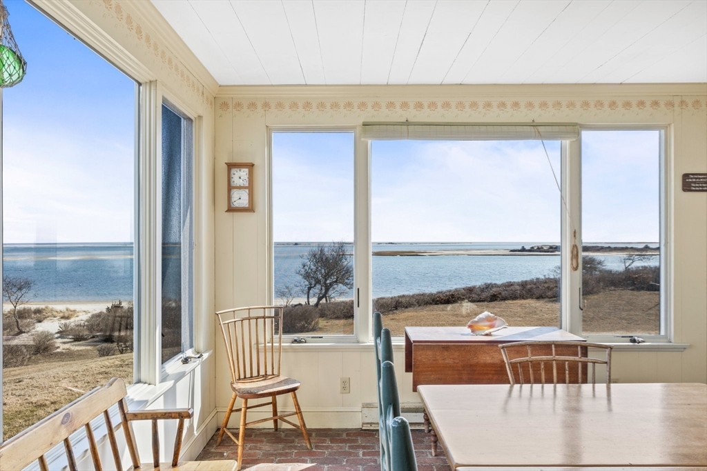 504 Old Harbor Road Chatham, MA 02633 - Photo 22 of 42 a living room with a floor to ceiling window and wooden floor