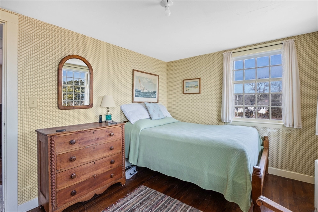 504 Old Harbor Road Chatham, MA 02633 - Photo 26 of 42 a bedroom with a bed and a mirror