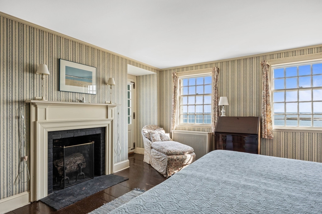 504 Old Harbor Road Chatham, MA 02633 - Photo 28 of 42 a bedroom with furniture and a fireplace