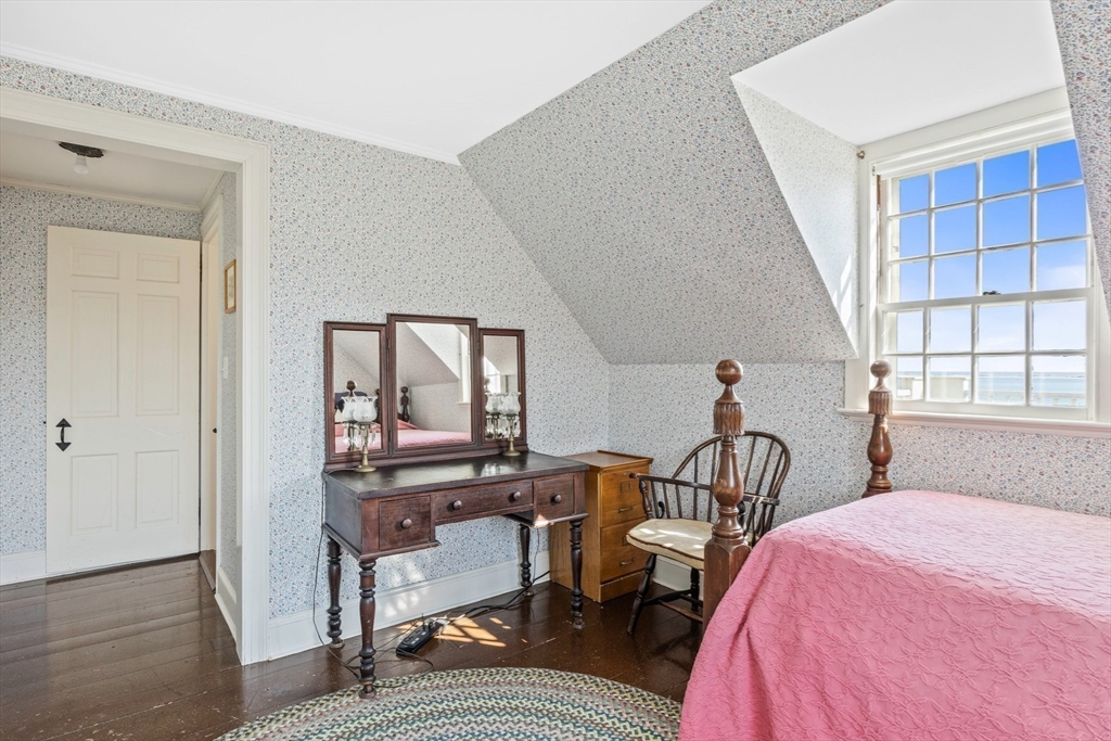 504 Old Harbor Road Chatham, MA 02633 - Photo 31 of 42 a bedroom with a bed window and walk in closet with wooden floor