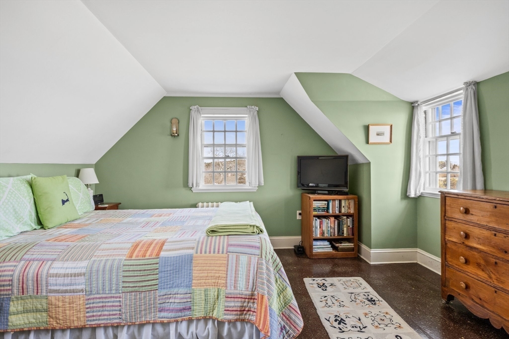 504 Old Harbor Road Chatham, MA 02633 - Photo 33 of 42 a bedroom with a bed and a flat screen tv