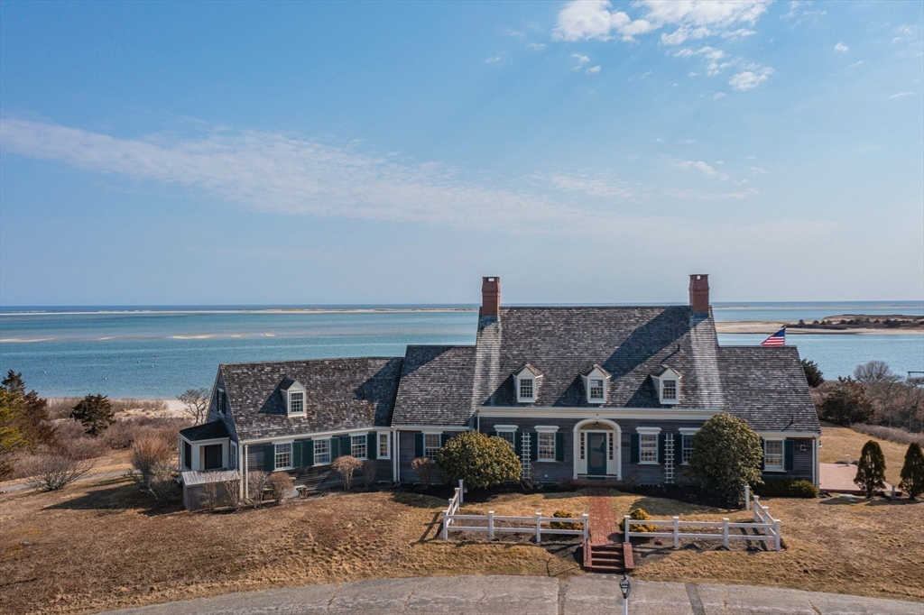 504 Old Harbor Road Chatham, MA 02633 - Photo 40 of 42 a front view of a house with a ocean view