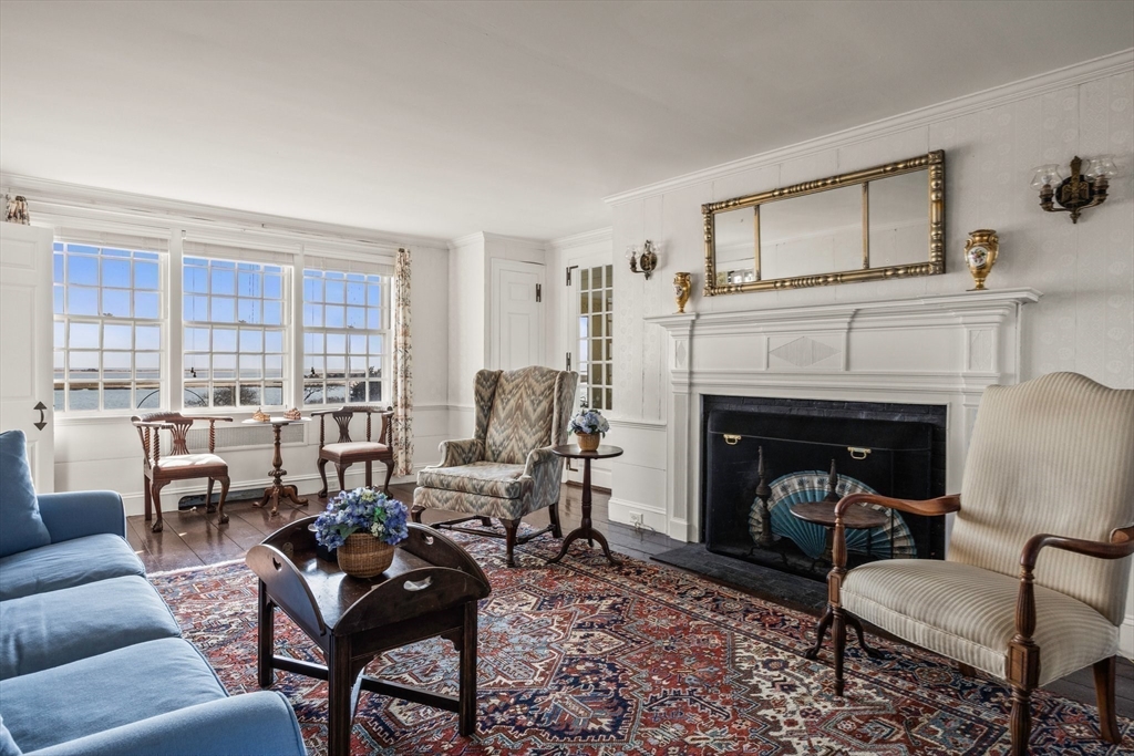 504 Old Harbor Road Chatham, MA 02633 - Photo 9 of 42 a living room with furniture and a fireplace