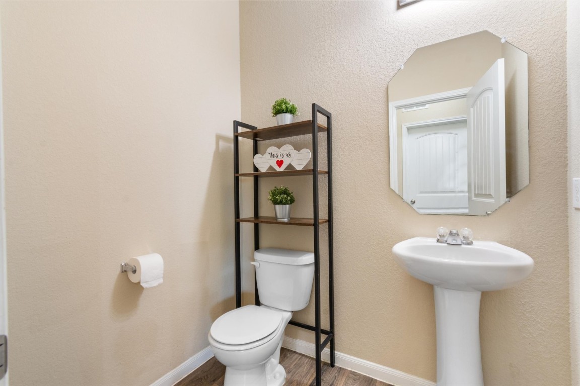 11620 Carbrook Road Manor, TX 78653 - Photo 11 of 40 a bathroom with a toilet sink and mirror