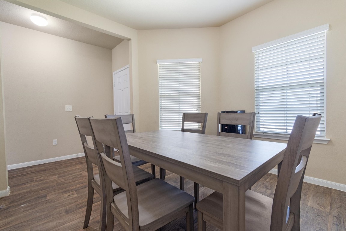 11620 Carbrook Road Manor, TX 78653 - Photo 12 of 40 a view of a dining room with furniture and wooden floor