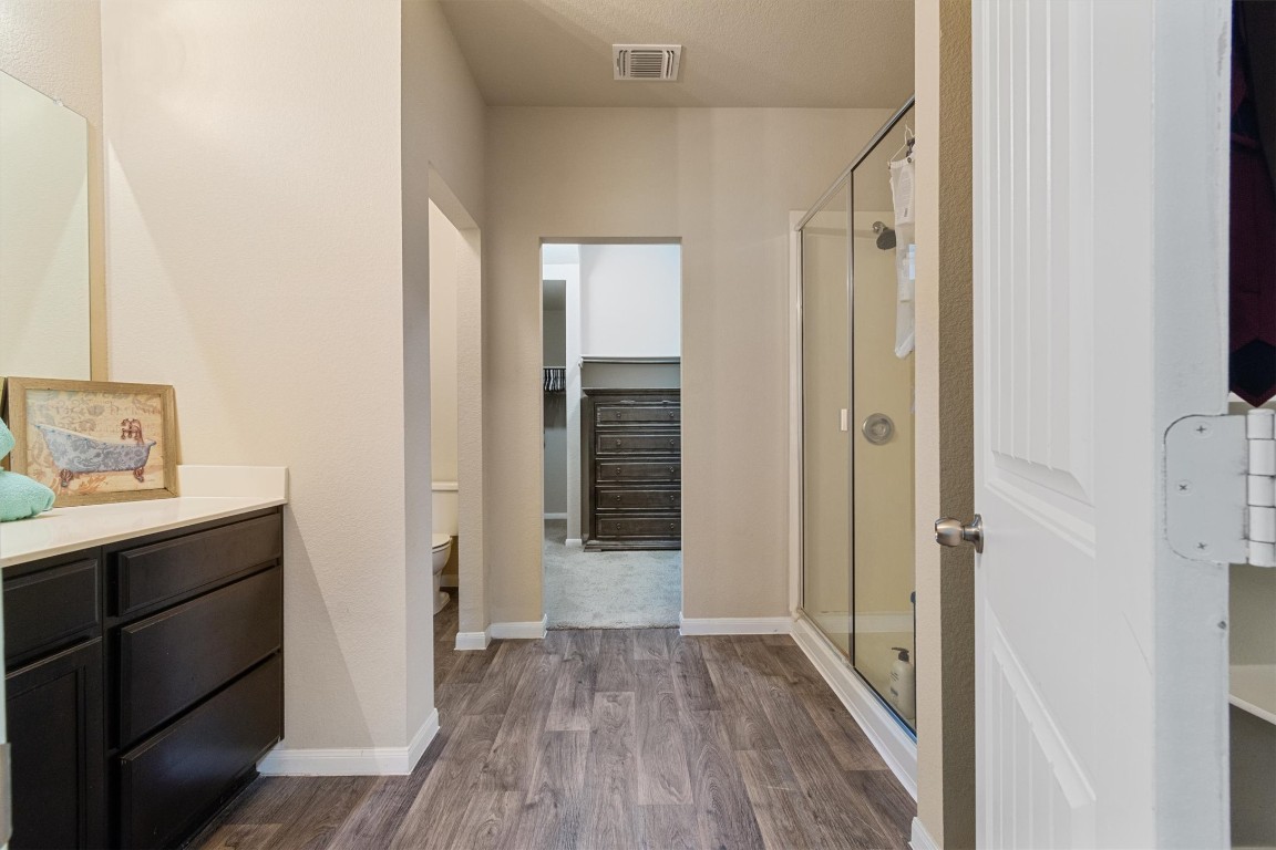 11620 Carbrook Road Manor, TX 78653 - Photo 19 of 40 a view of a hallway with wooden floor and closet