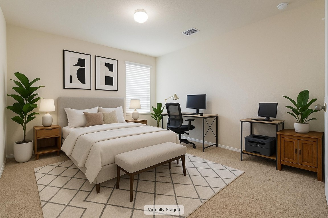 11620 Carbrook Road Manor, TX 78653 - Photo 24 of 40 a bedroom with a large bed and a desk