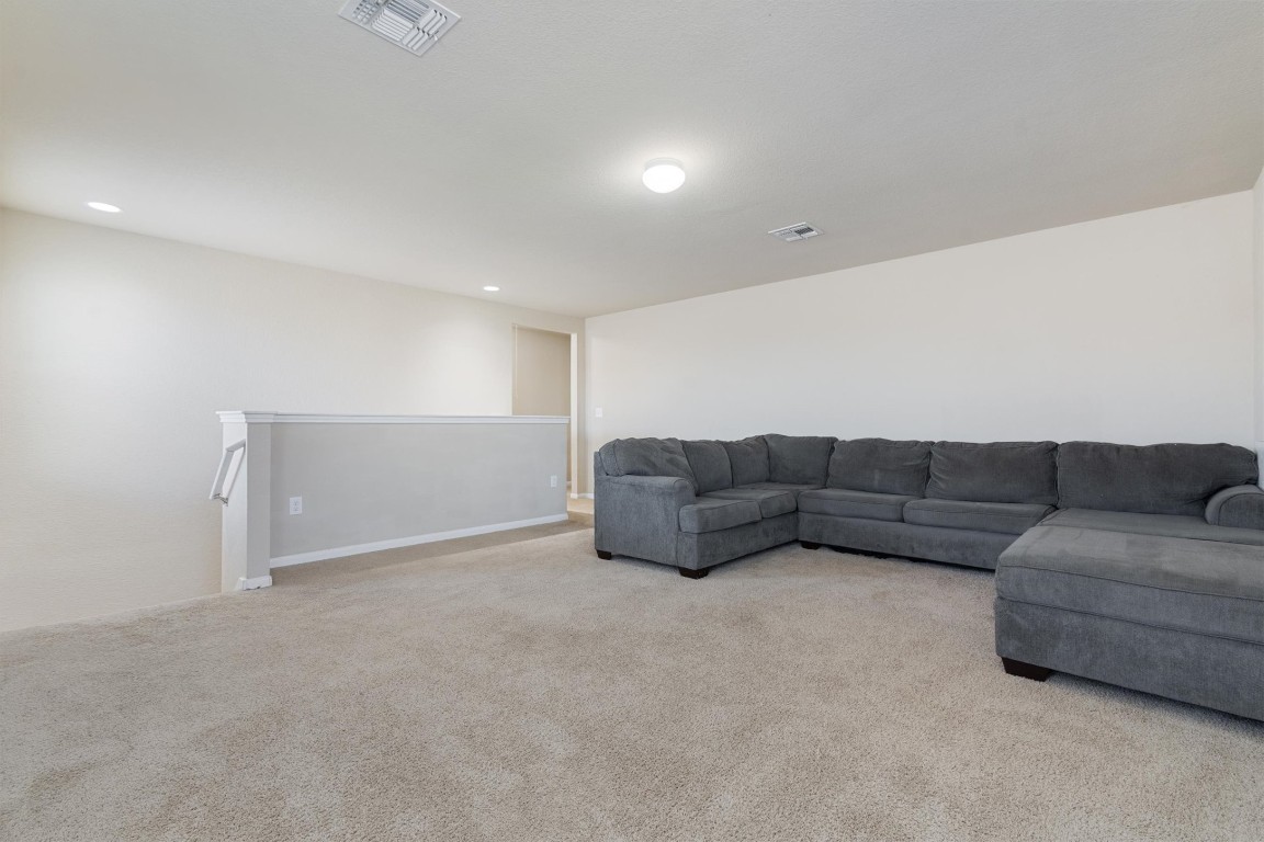 11620 Carbrook Road Manor, TX 78653 - Photo 27 of 40 a living room with furniture and a couch