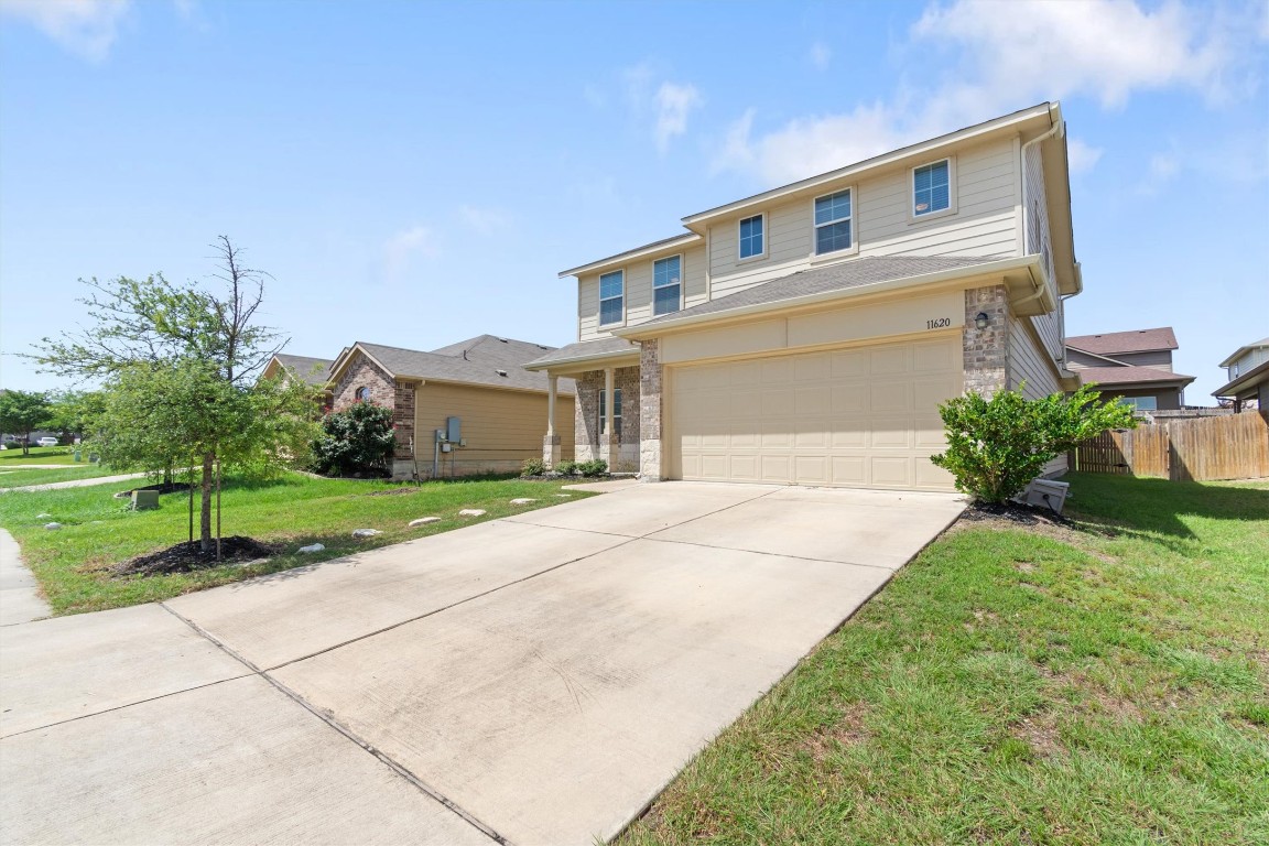 11620 Carbrook Road Manor, TX 78653 - Photo 39 of 40 a front view of a house with a yard and garage