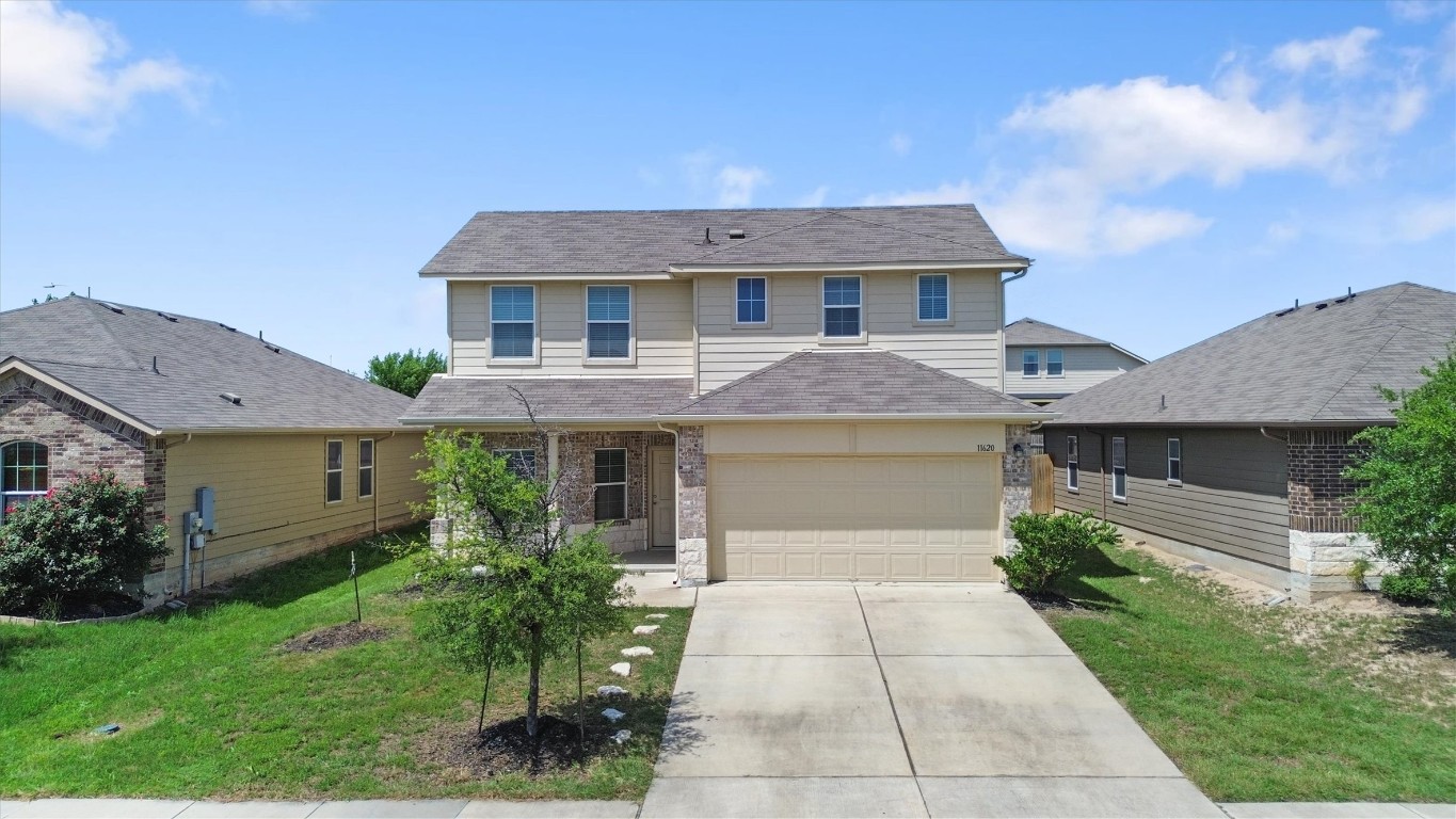 11620 Carbrook Road Manor, TX 78653 - Photo 4 of 40 a front view of a house with garden