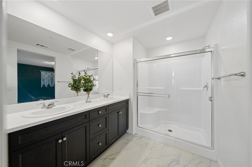 41979 Rondo Street, Unit 1106 Murrieta, CA 92562 - Photo 11 of 18 a bathroom with a double vanity sink mirror and shower