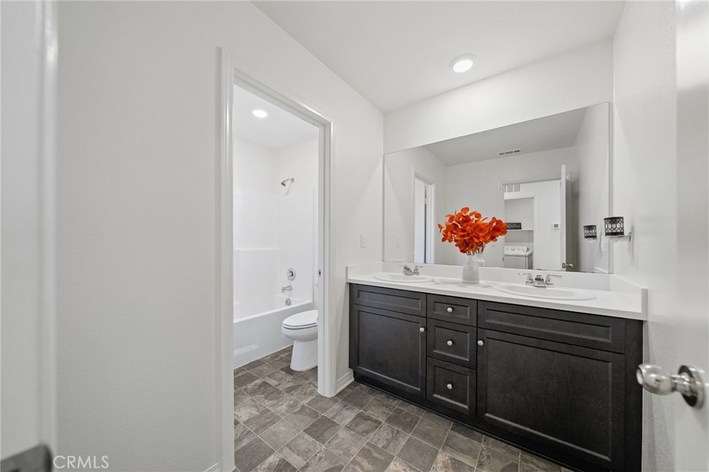41979 Rondo Street, Unit 1106 Murrieta, CA 92562 - Photo 14 of 18 a bathroom with a sink and a mirror
