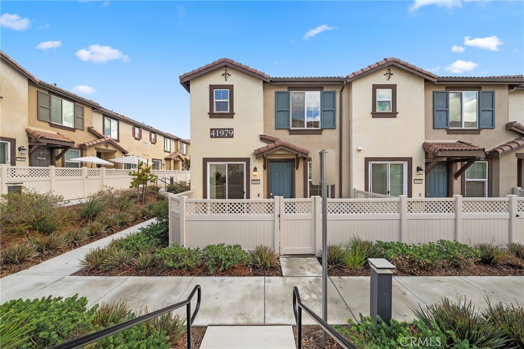 41979 Rondo Street, Unit 1106 Murrieta, CA 92562 - Photo 18 of 18 a front view of a house with a yard