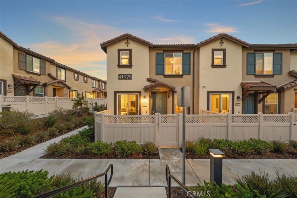 41979 Rondo Street, Unit 1106 Murrieta, CA 92562 - Photo 5 of 18 a front view of a house with a yard