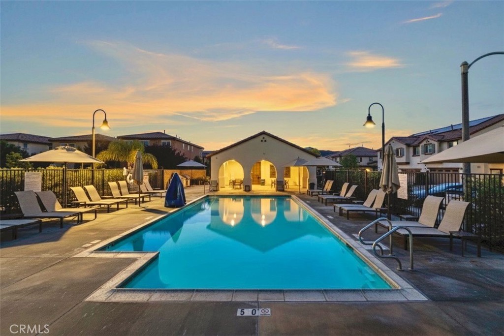 41979 Rondo Street, Unit 1106 Murrieta, CA 92562 - Photo 6 of 18 a front view of a house with swimming pool
