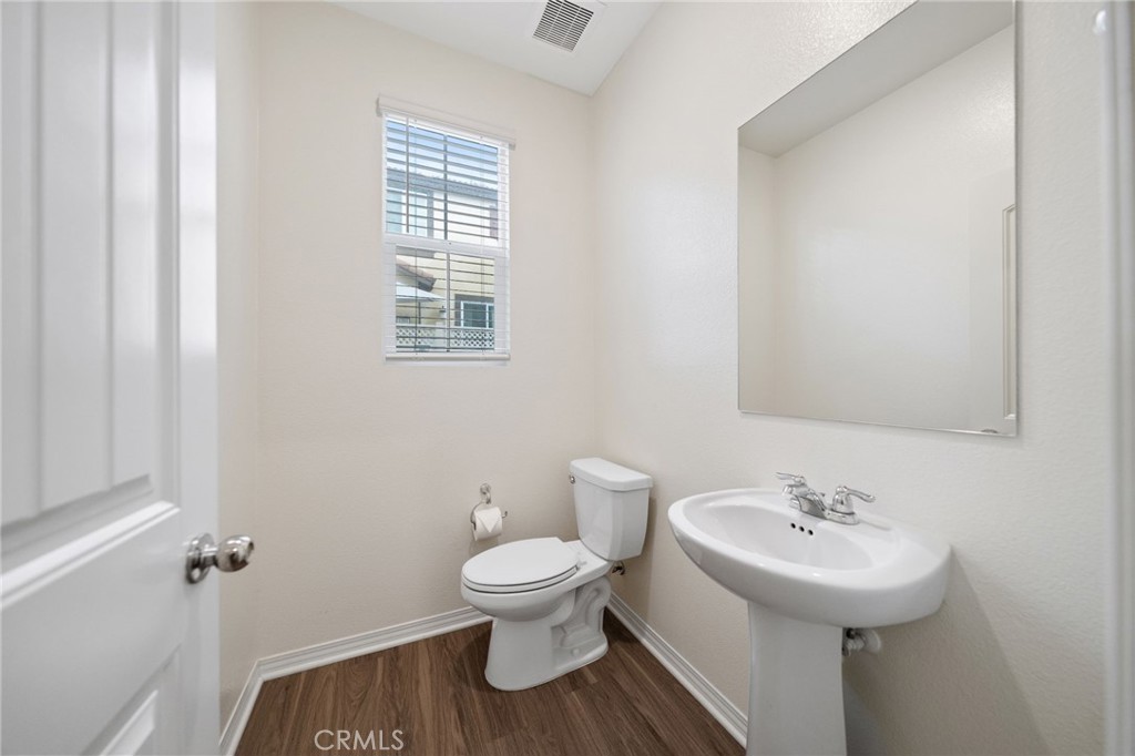 41979 Rondo Street, Unit 1106 Murrieta, CA 92562 - Photo 10 of 18 a bathroom with a sink toilet and a mirror