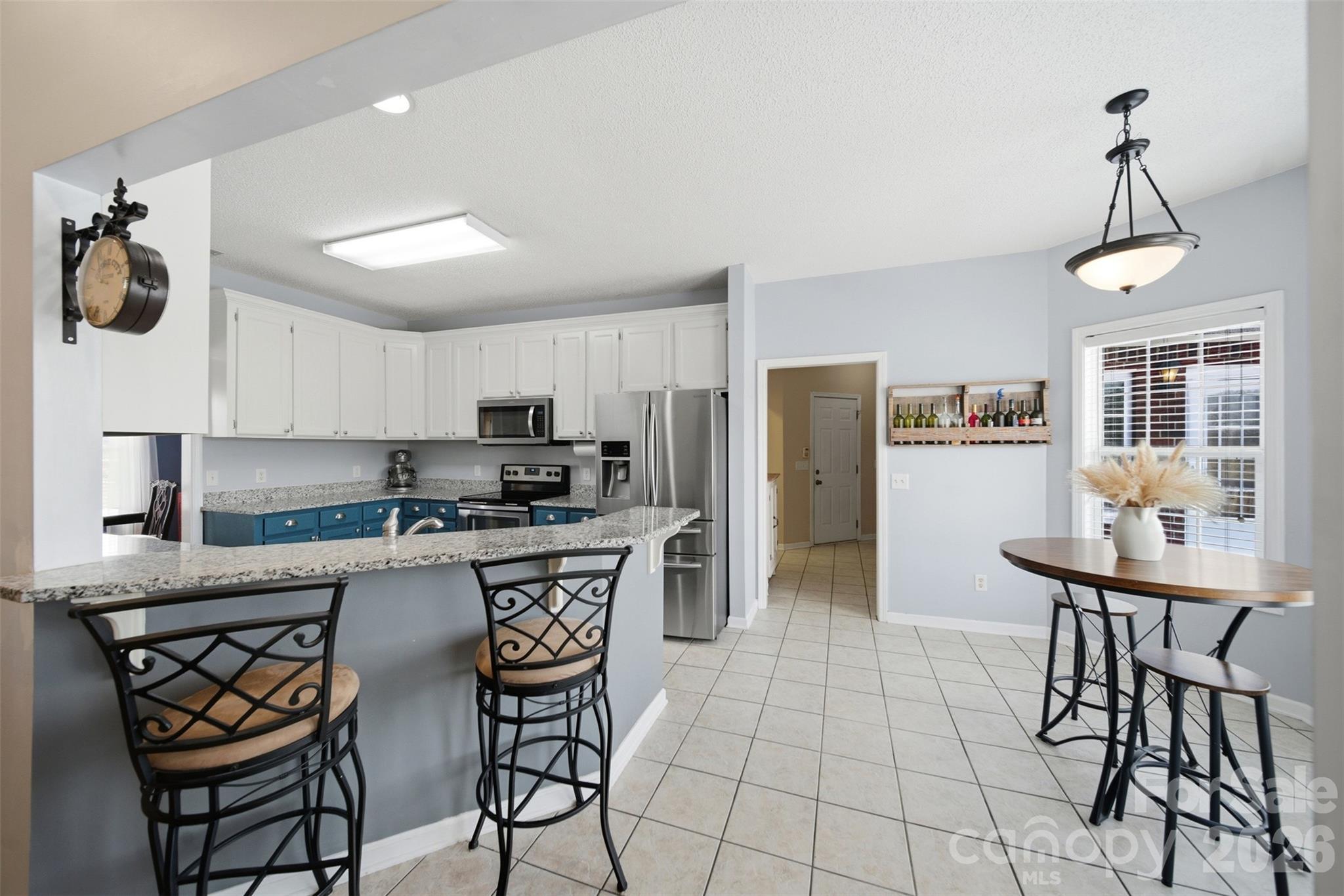 2535 Citrus Lane Sumter, SC 29153 - Photo 12 of 47 a kitchen with stainless steel appliances a dining table chairs refrigerator and microwave