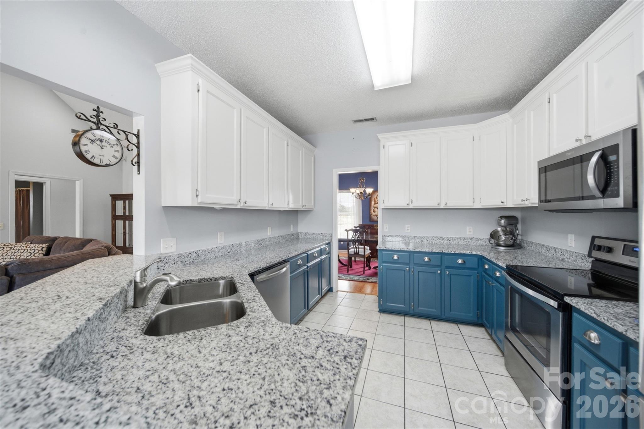 2535 Citrus Lane Sumter, SC 29153 - Photo 13 of 47 a kitchen with granite countertop a sink a stove top oven a clock and cabinets