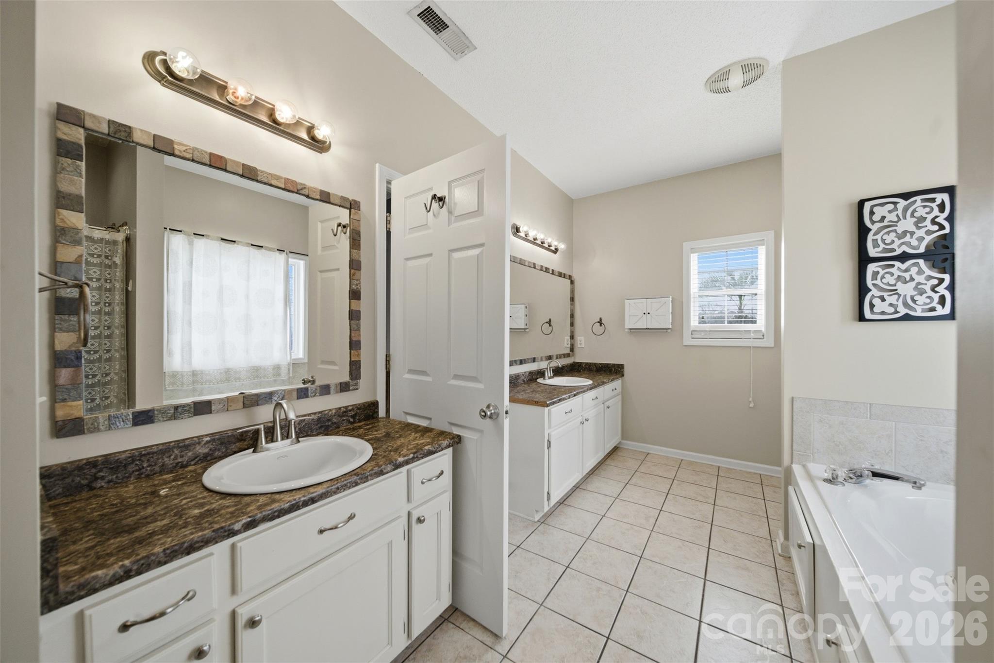 2535 Citrus Lane Sumter, SC 29153 - Photo 22 of 47 a spacious bathroom with a granite countertop sink mirror and bathtub