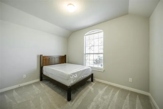 a bedroom with a bed and window