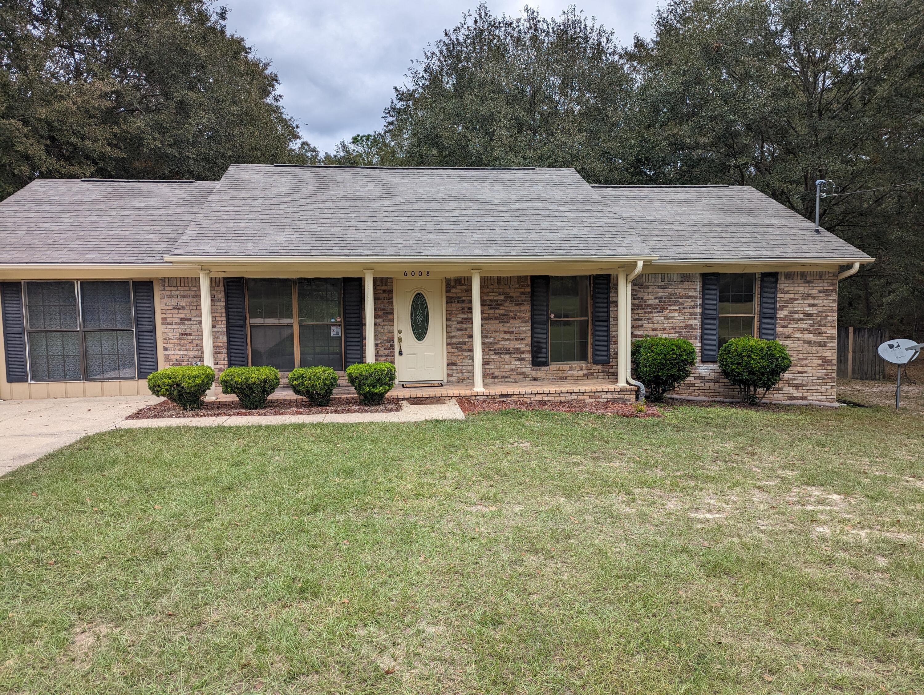 6008 Old Bethel Road Crestview, FL 32536 - Photo 1 of 36 a view of a house with garden and yard