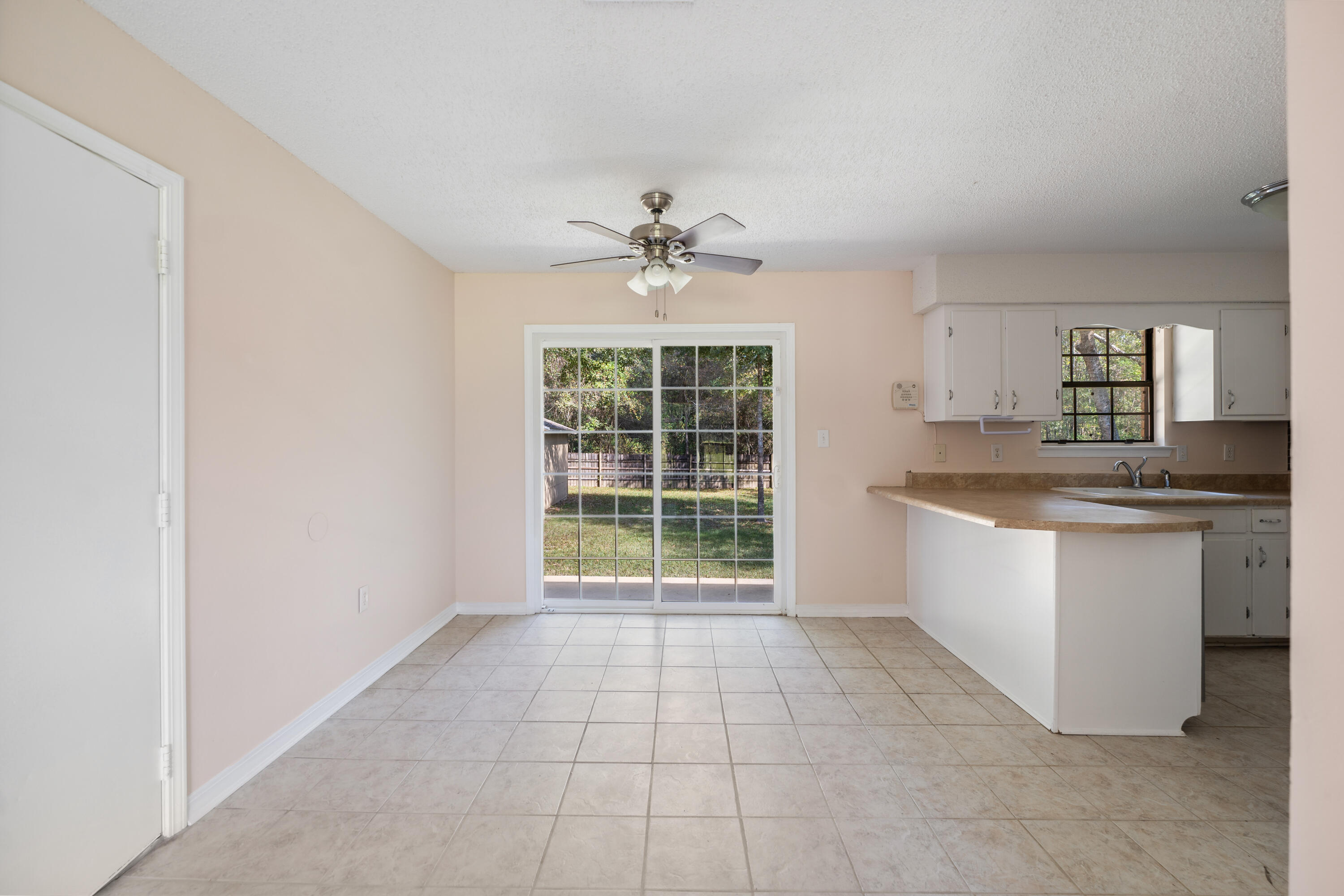 6008 Old Bethel Road Crestview, FL 32536 - Photo 13 of 36 a kitchen with a stove a sink and a refrigerator