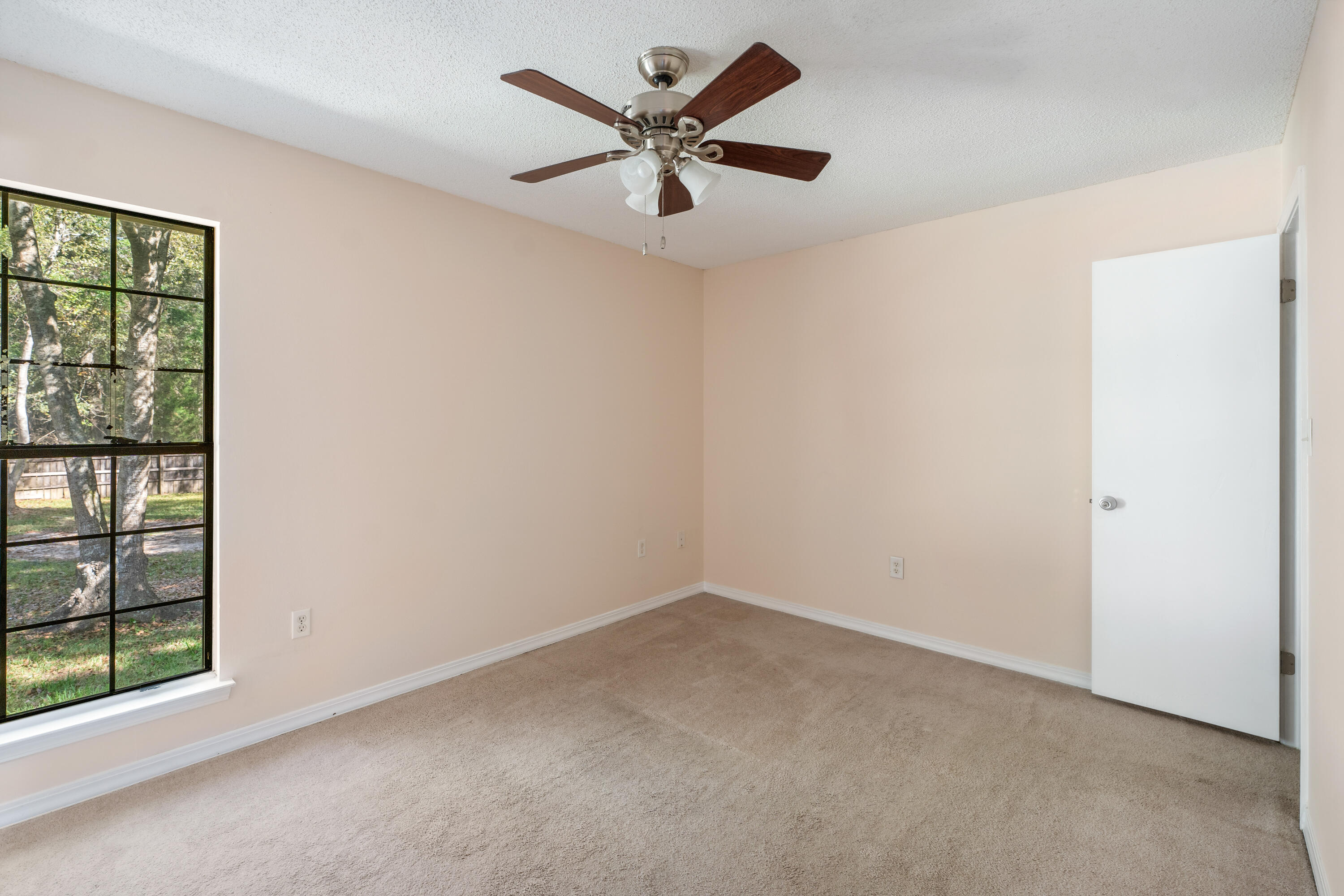 6008 Old Bethel Road Crestview, FL 32536 - Photo 16 of 36 an empty room with windows and fan