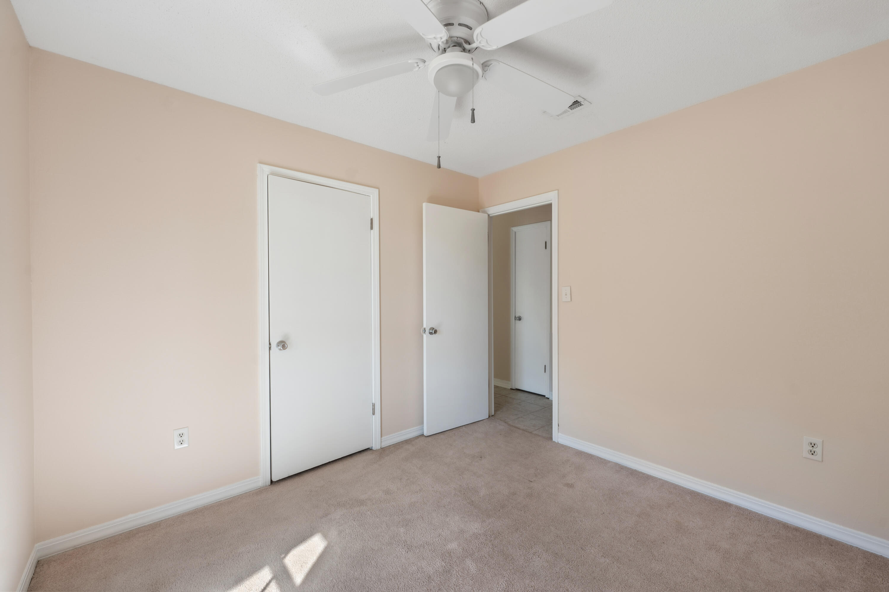 6008 Old Bethel Road Crestview, FL 32536 - Photo 18 of 36 an empty room with a chandelier fan and closet area