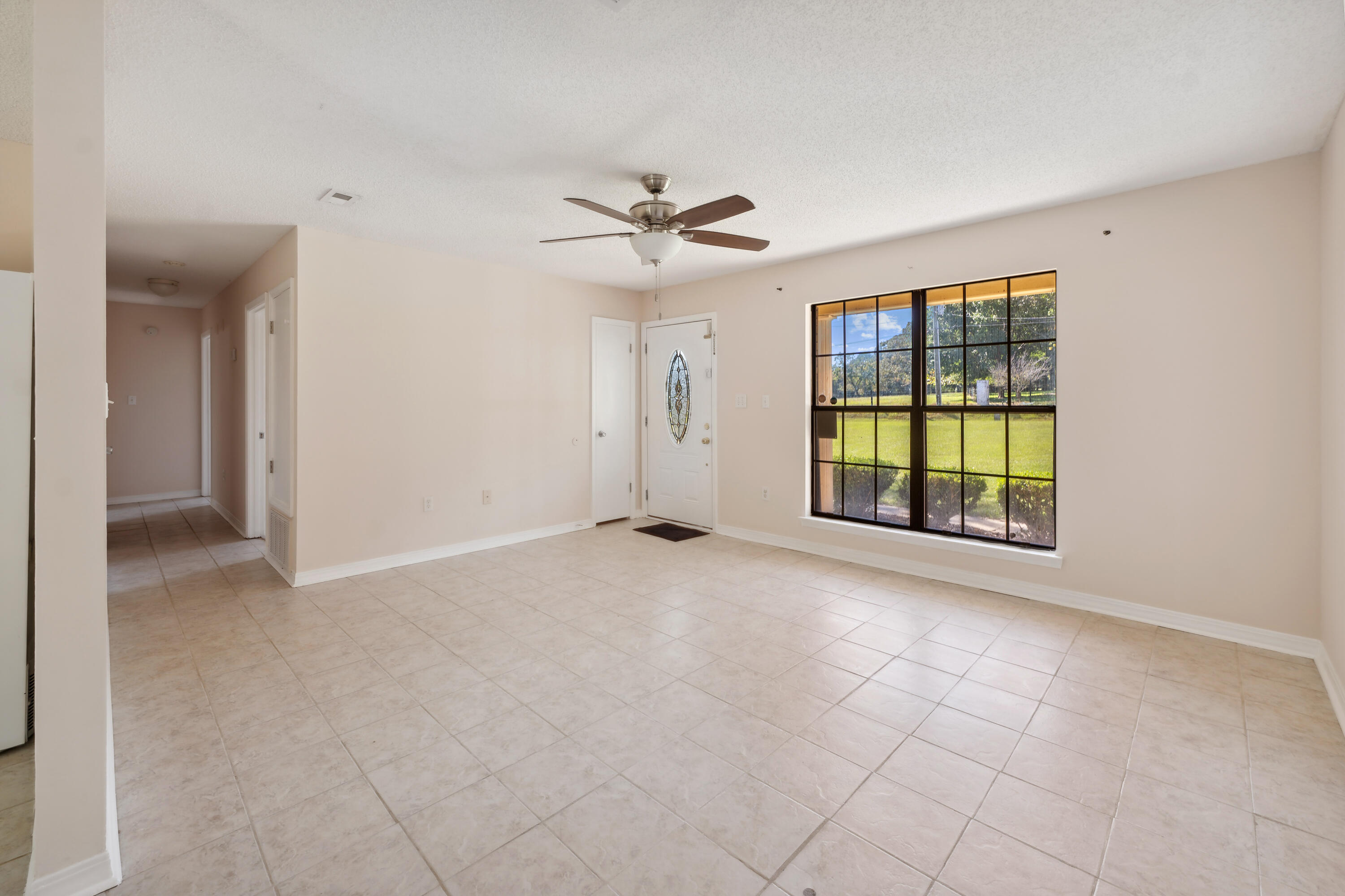 6008 Old Bethel Road Crestview, FL 32536 - Photo 8 of 36 an empty room with windows and ceiling fan