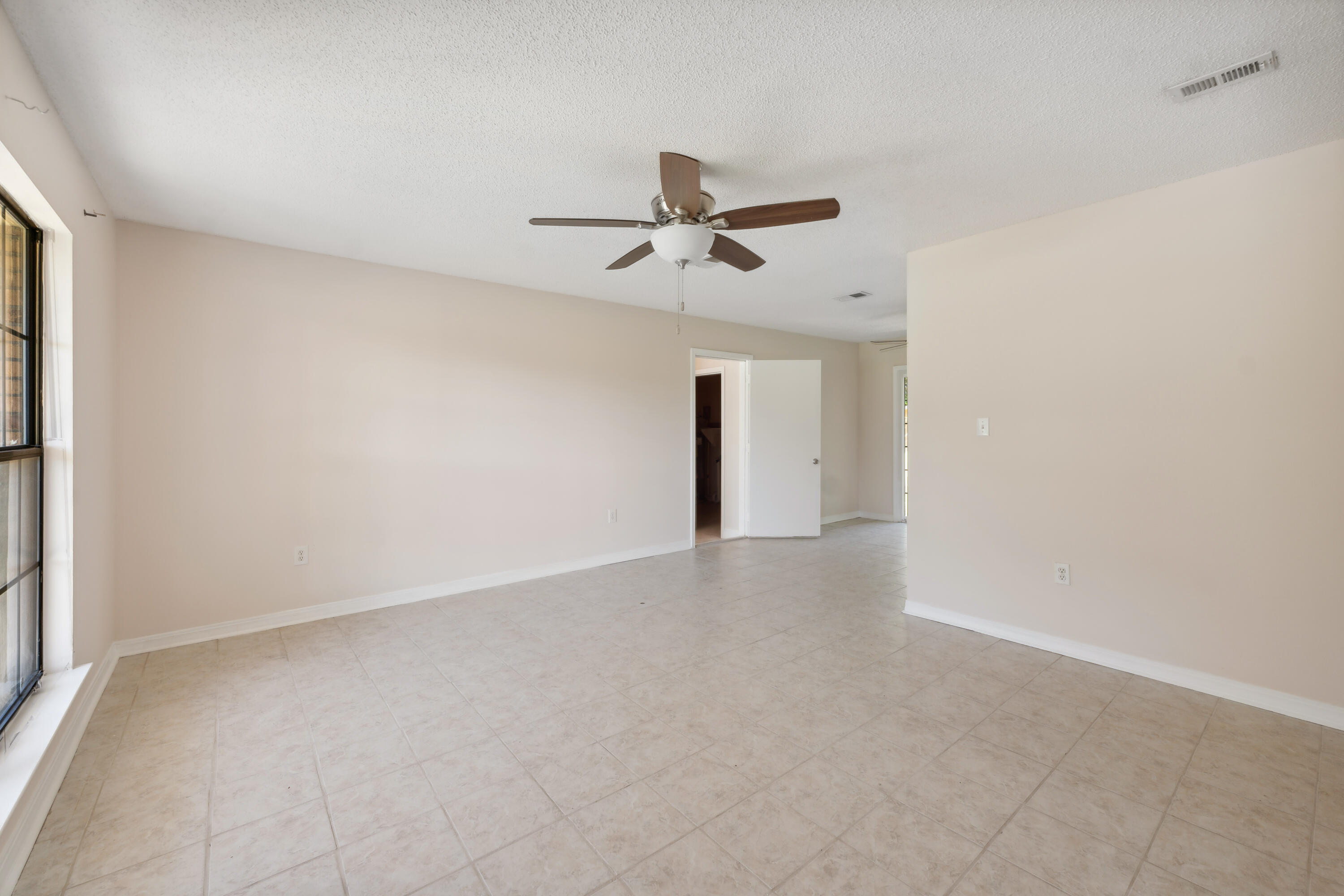 6008 Old Bethel Road Crestview, FL 32536 - Photo 9 of 36 a view of a livingroom with a ceiling fan and window