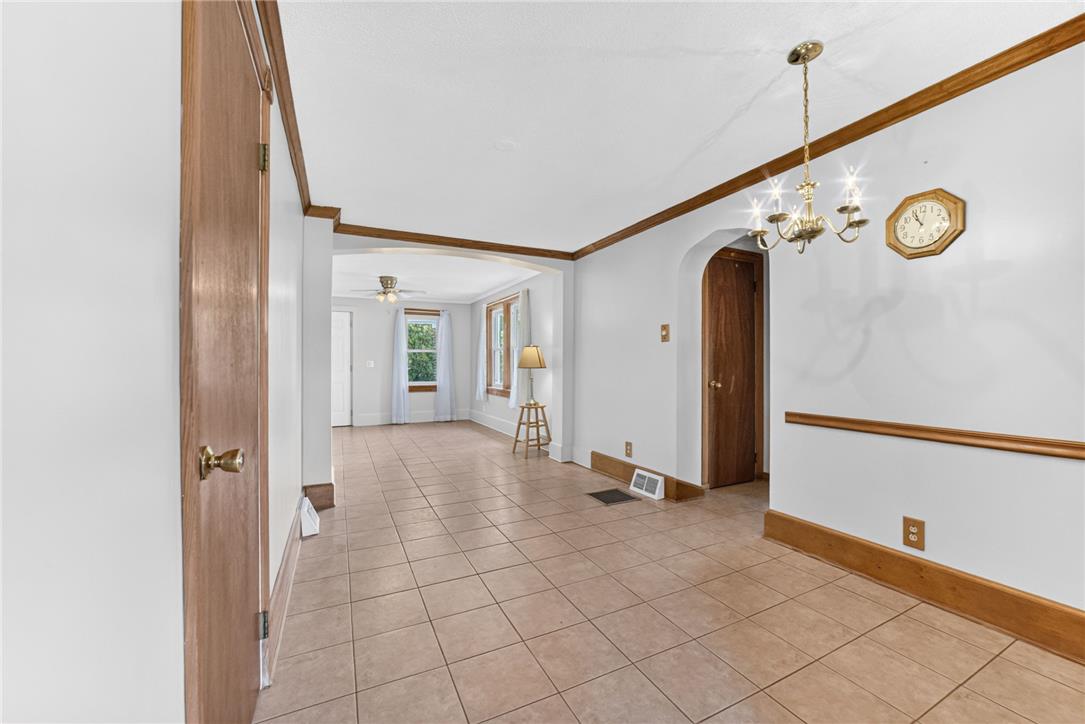 1166 Stones Crossing Road Easton, PA 18045 - Photo 14 of 35 A well-maintained living area showcases practical tile flooring and classic wood trim details.