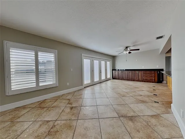 a view of empty room with a fireplace and window