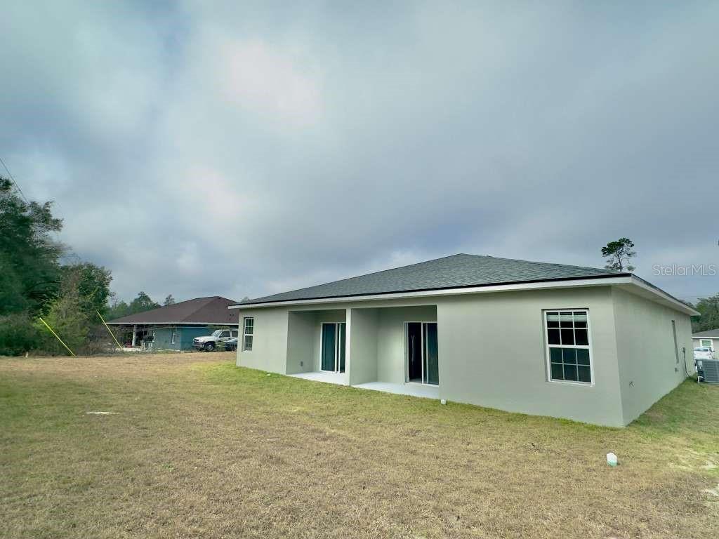 15885 Southwest 35th Court Road, Unit 1 Ocala, FL 34473 - Photo 26 of 27 a house view with a backyard space