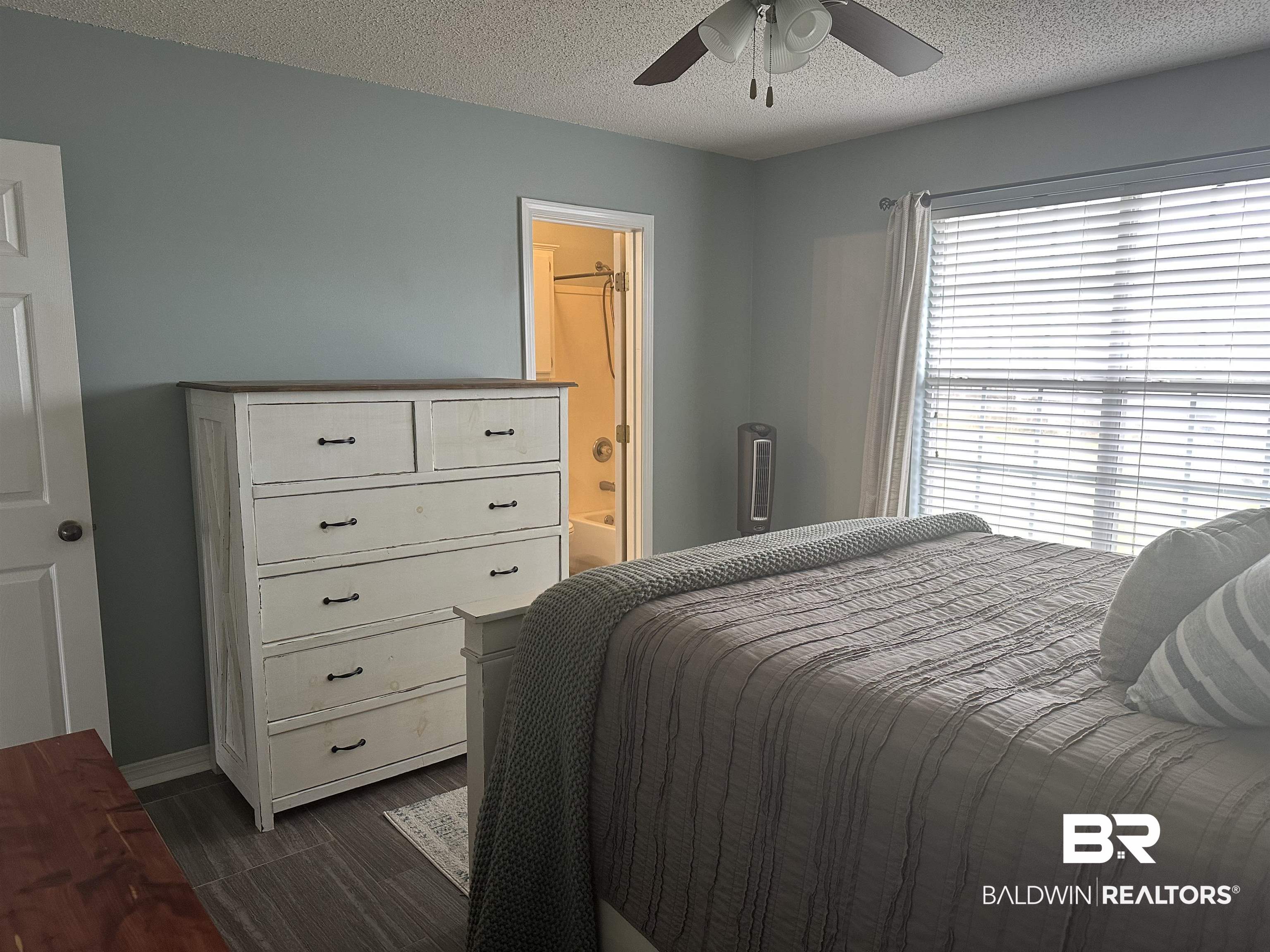 4882 Rebecca Place Mobile, AL 36695 - Photo 15 of 29 Bedroom with ensuite bath, baseboards, a textured ceiling, and a ceiling fan