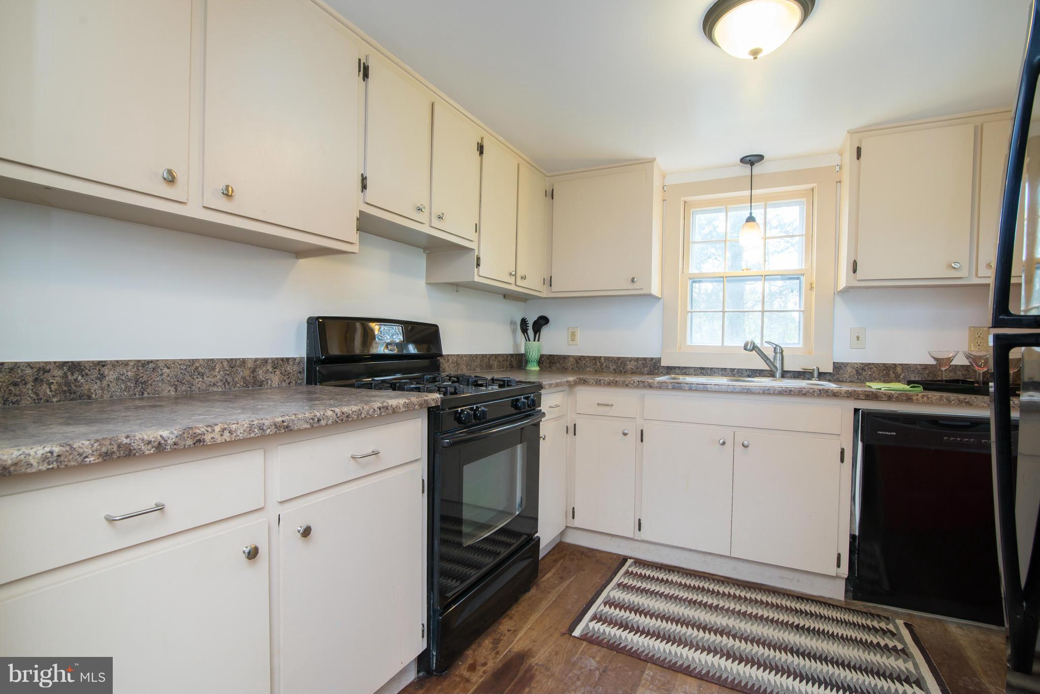 443 Turner Road Shepherdstown, WV 25443 - Photo 14 of 30 a kitchen with granite countertop cabinets stainless steel appliances a sink and a window
