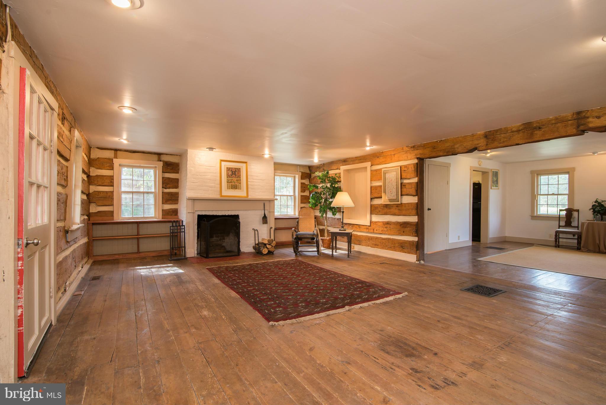 443 Turner Road Shepherdstown, WV 25443 - Photo 3 of 30 a view of a livingroom with wooden floor and a fireplace