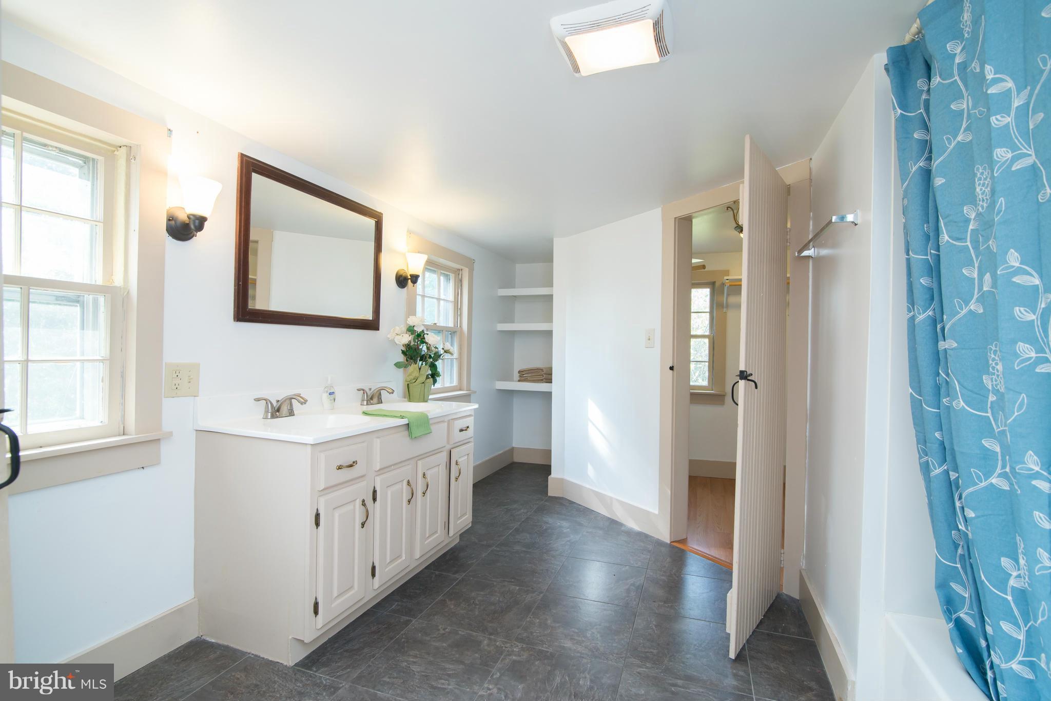 443 Turner Road Shepherdstown, WV 25443 - Photo 22 of 30 a bathroom with a double vanity sink a mirror and a shower