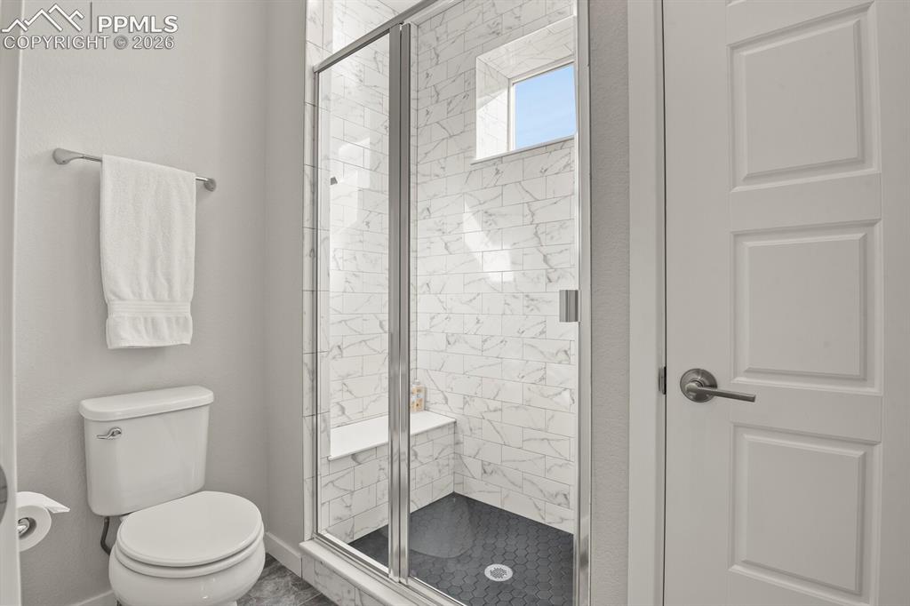 11314 Modern Meadow Loop Colorado Springs, CO 80921 - Photo 19 of 30 a bathroom with a toilet and a shower
