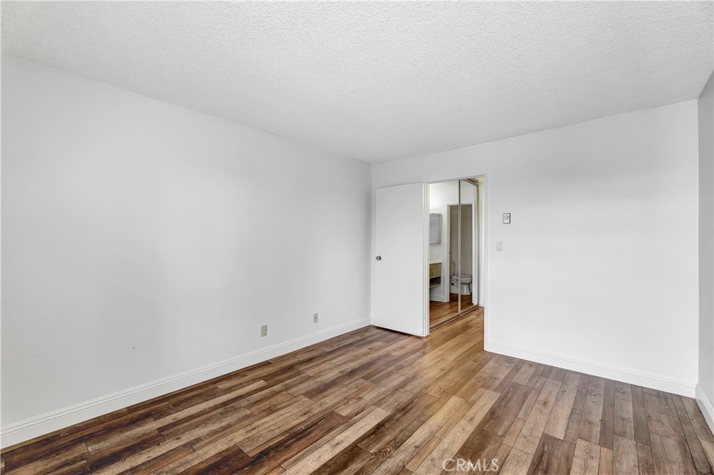 5585 Pacific Coast Highway, Unit 342 Long Beach, CA 90804 - Photo 11 of 32 a view of an empty room and wooden floor