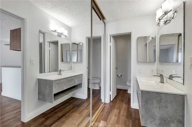 a bathroom with a double vanity sink mirror and bathtub