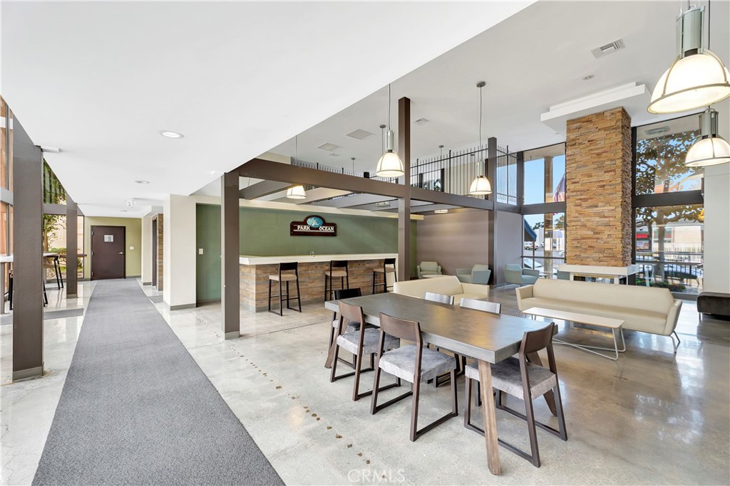 5585 Pacific Coast Highway, Unit 342 Long Beach, CA 90804 - Photo 18 of 32 a dining hall with stainless steel appliances kitchen island granite countertop a table and chairs