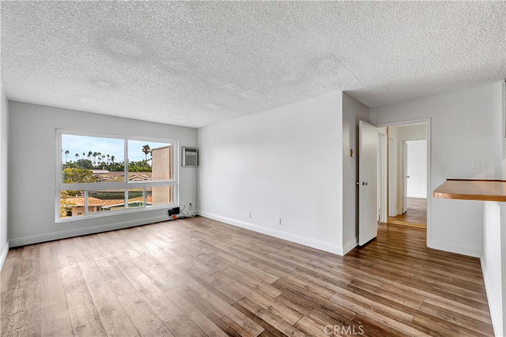 5585 Pacific Coast Highway, Unit 342 Long Beach, CA 90804 - Photo 2 of 32 a view of an empty room and wooden floor