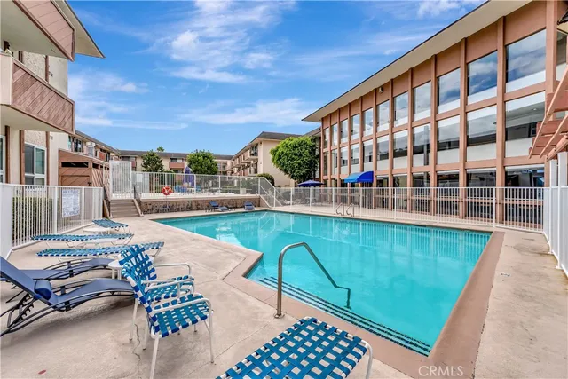 a swimming pool view with a outdoor seating space