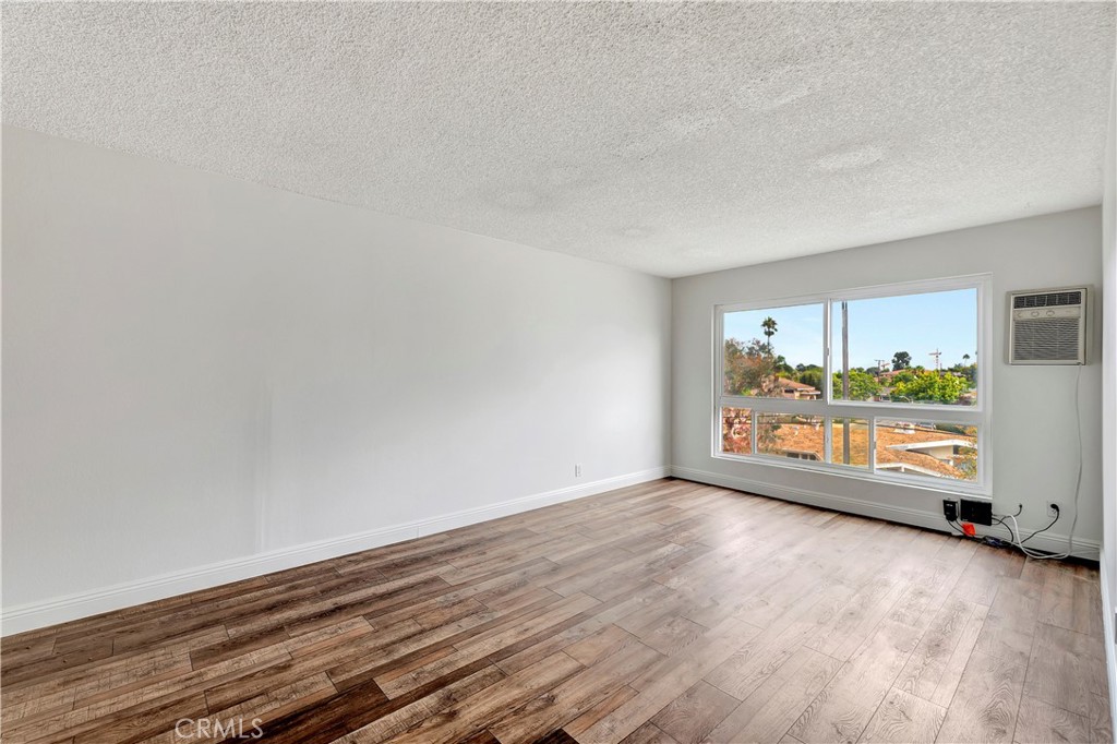5585 Pacific Coast Highway, Unit 342 Long Beach, CA 90804 - Photo 3 of 32 a view of an empty room and wooden floor