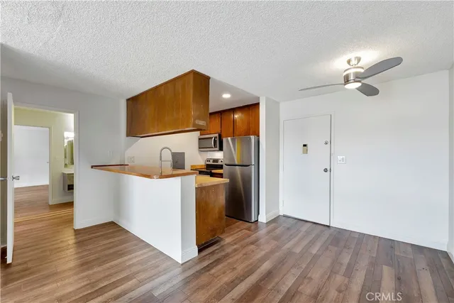 a kitchen with a sink cabinets and wooden floor