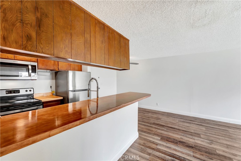 5585 Pacific Coast Highway, Unit 342 Long Beach, CA 90804 - Photo 7 of 32 a kitchen with a sink and cabinets