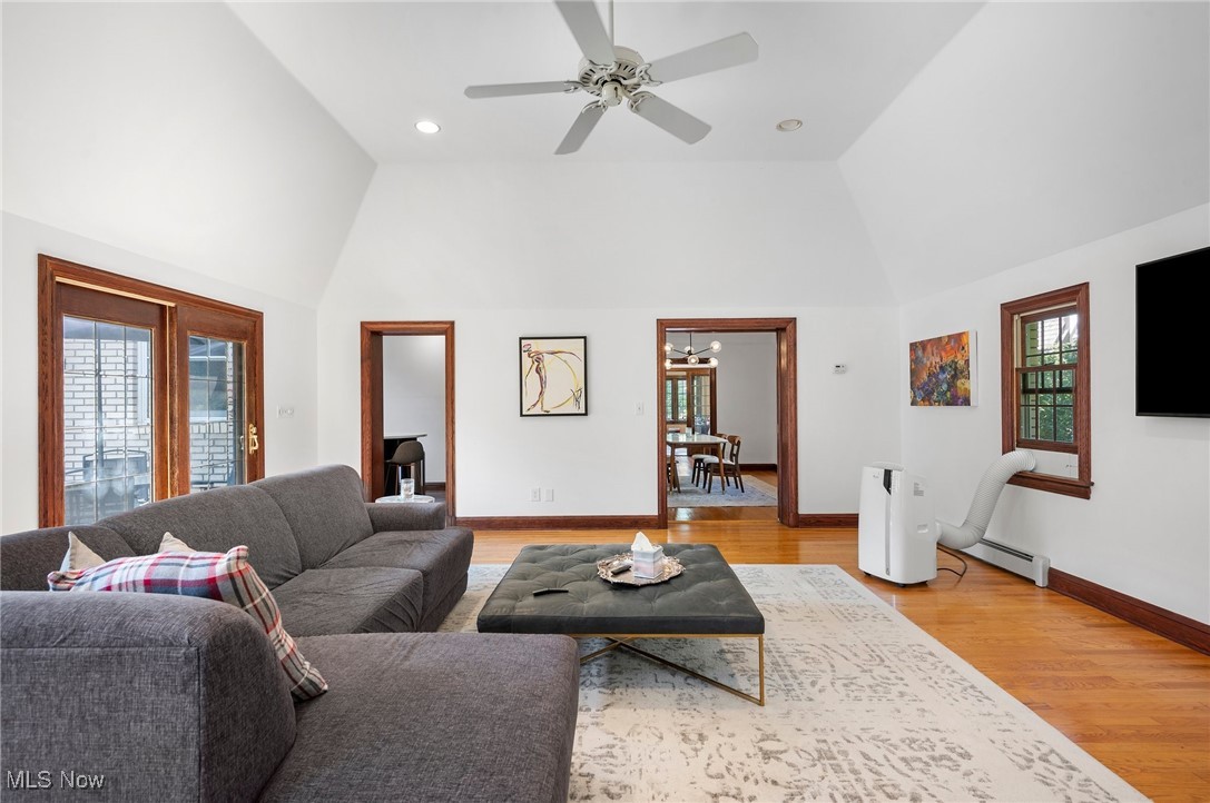 2213 Coventry Road Cleveland, OH 44118 - Photo 18 of 46 Living room with high vaulted ceiling, a baseboard heating unit, ceiling fan, and light hardwood / wood-style flooring